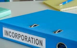 Blue binder labeled incorporation on desk