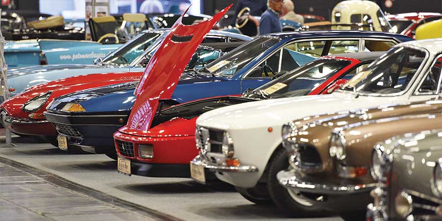 Learn how to protect your classic cars from taxes with TaxFree RV. This vintage car display at an auto show highlights the importance of safeguarding your investment. Discover smart tax strategies to preserve the value of your prized vehicles today.