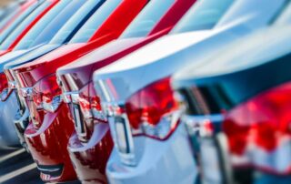Row of parked red and silver cars