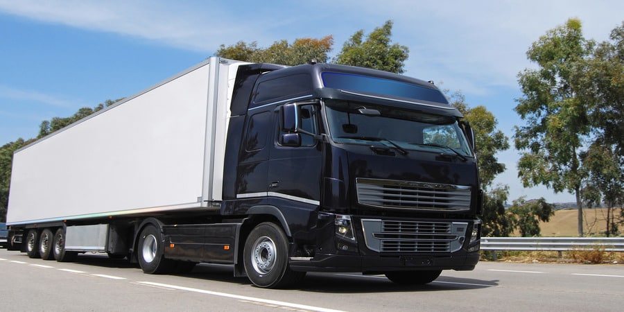 Discover how a Montana LLC for Commercial Truck Owners can optimize taxes while keeping your fleet, like this sleek truck, on the road legally.